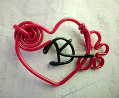 a pair of red and black heart shaped hair clips