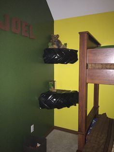 there is a bunk bed in the room with two black bags on top of it