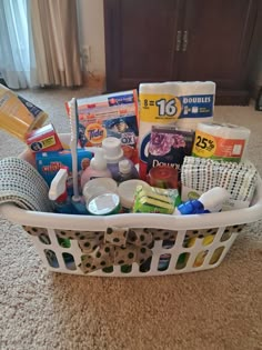 a white basket filled with lots of items on top of a carpeted floor next to a window