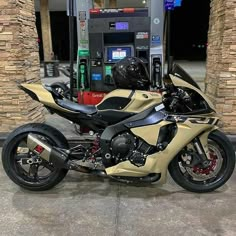 a motorcycle parked in front of a gas pump