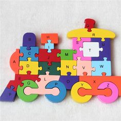 colorful wooden puzzle pieces arranged in the shape of a train