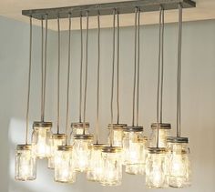 an image of a light fixture with mason jars hanging from it