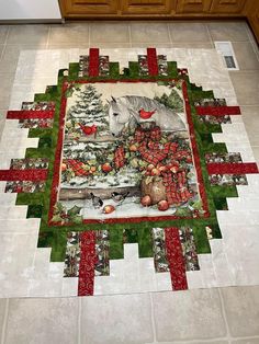 a quilted table topper with a horse and christmas decorations on it in a kitchen