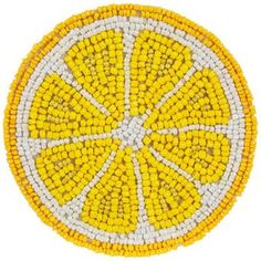 a yellow and white beaded coaster with an orange slice in the center on a white background