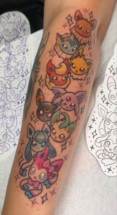 a person with a tattoo on their arm that has many different pokemon characters all over it