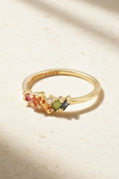 Suzanne Kalan's ring is encrusted with baguette-cut rainbow sapphires and tiny diamonds in the designer's signature 'Fireworks' setting - the result really is as spectacular as those you see in the sky. It's crafted from 18-karat yellow gold and perfect for stacking. Rwinbow Ring, Baguette Mothers Ring, Senior Rings, Ethereal Jewelry, Sister Rings, Ring Inspo, Rainbow Sapphires, Mom Ring, Suzanne Kalan