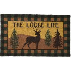 the lodge life door mat with deer and pine trees on green checkerboard background