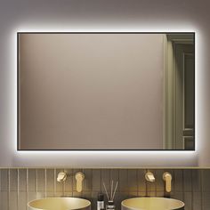 a bathroom with two sinks and a large mirror above it's counter top area