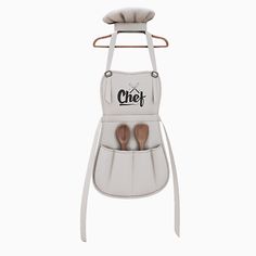 an oven mitt with two wooden spoons in it and the word chef written on it