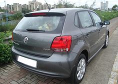 a grey car parked on the side of a road