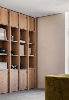 a living room filled with lots of wooden shelves