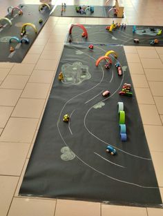 children's play area with toys on the floor and large rug in front of them