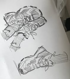 two drawings of shoes sitting on top of a piece of paper