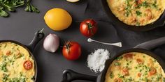 three pans filled with omelets, tomatoes and other ingredients on a table