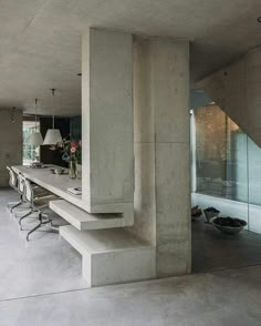 an image of a concrete dining room with chairs and tables in the center, on instagram