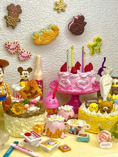 a table topped with lots of toys and cakes