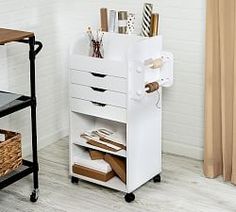 a white desk with drawers and some items on it