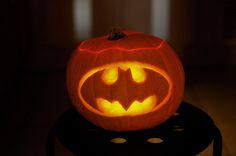 a pumpkin carved to look like a batman