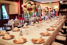 a long table with plates and napkins is set up for a formal dinner or party