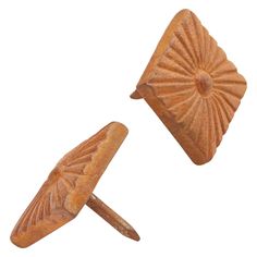 pair of carved wooden cufflinks on white background