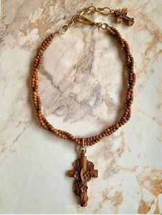 "Beautiful vintage Victorian French wooden cross necklace. This stunning necklace features an amazing vintage French hand-carved cross with carved cascading flowers.  The cross is antique, and is in remarkable, perfect condition. I added two strands of antique hand-carved tiny wooden beads to form the necklace. A small carved wood cross dangles from the chain.  The cross measures 2-5/8\" x 1- 3/8\". Pendant drop is 3-1/4\". Additional brass chain allows adjustability. The necklace measures  16\" Wooden Cross Necklace, Carved Flowers, Cascading Flowers, Victorian Pendants, Wood Cross, Wood Crosses, Wooden Cross, Vintage Victorian, Stunning Necklace