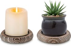 two candles are sitting next to each other with succulents in the middle