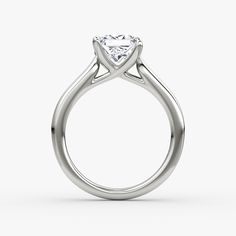 a white gold ring with a heart shaped diamond in the center, on a white background