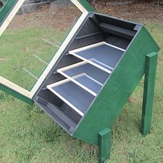 an upside down mirror sitting in the grass