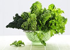 a bowl filled with lots of green leafy vegetables