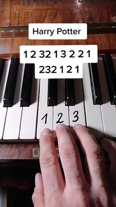 a person is playing the piano with numbers on each side and their fingers pointing at it