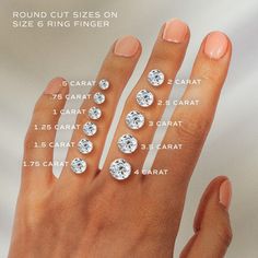 a woman's hand with five different sizes of diamonds on her fingers and four rows of diamond rings in the middle