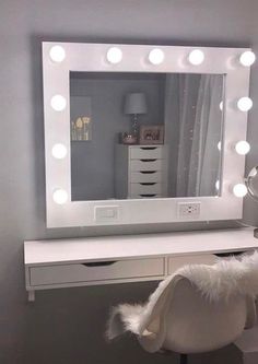 a white desk with a mirror and lights on it