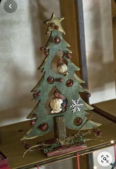 a small christmas tree with ornaments on it