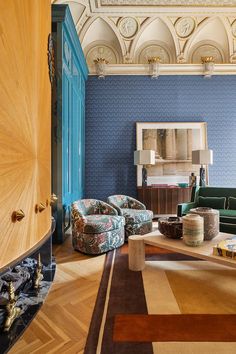 a living room filled with furniture and blue walls