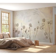 a bed sitting under a window next to a wooden floor