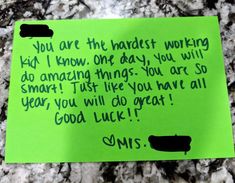 a note written to someone on the side of a green piece of paper that says, you are the happest working kid i know one day, you will do amazing things