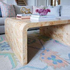 a coffee table with books on it in front of a couch