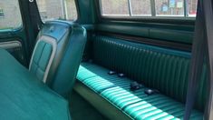 the interior of an old car with green leather seats