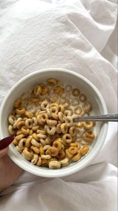 a person is eating cereal in a bowl