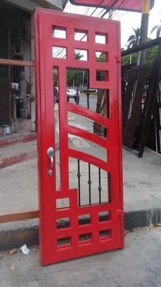 a red door is open on the sidewalk