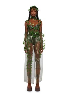 a woman in a bodysuit with plants on her chest and legs, standing against a white background