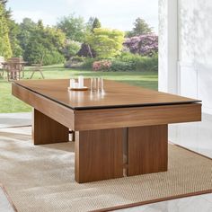 a wooden table sitting on top of a rug