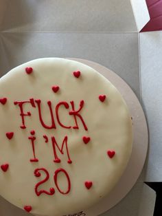 a white cake with red frosting that says f u k i m o on it