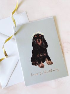 a card with a dog wearing a flower in its hair and the words happy birthday on it