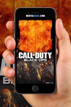 a person holding an iphone with the call of duty app on it's screen