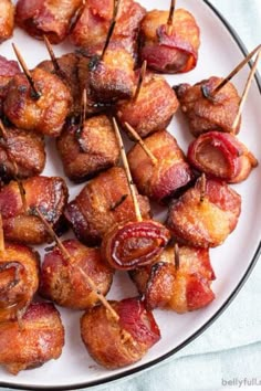 bacon wrapped in toothpicks on a white plate