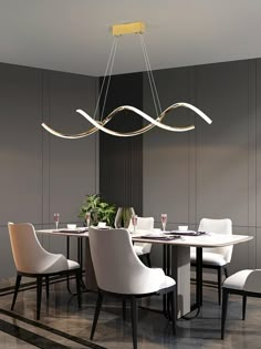 a dining room table with white chairs and a chandelier hanging from the ceiling