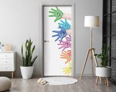 there are many hands painted on the door to make it look like they are coming out