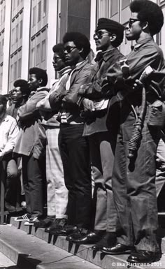 black and white photograph of men standing on steps