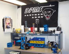 a workbench with tools and equipment in front of a black panther banner hanging on the wall